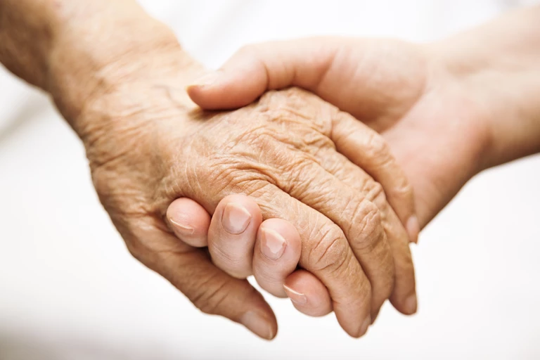 holding hands illustrating dignity in care