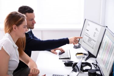 Man and women looking at invoice management software