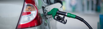 Car being fueled at a petrol station.