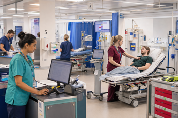 An NHS ward featuring staff using healthcare software.