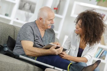 A lady going through paperwork with a man. 