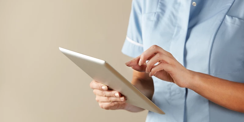 A nurse using best-in-breed software on a tablet device.