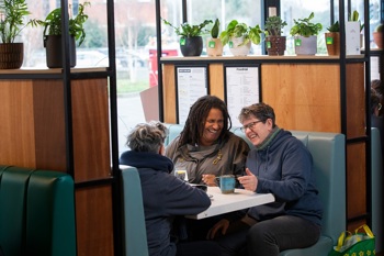 Social prescribing in action as three people meet through a support group.