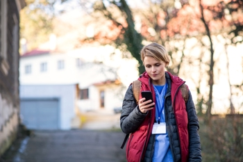 Female care worker using her mobile phone. 