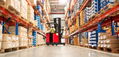 Worker In Forklift In Warehouse