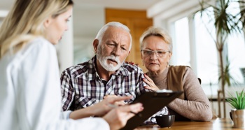 A patient and his wife engaging with a healthcare professional.