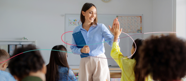 Teacher high fiving student in classroom