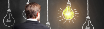A man stares at an illuminated light bulb