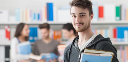 College student holding books in classroom