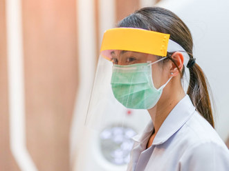 A woman dressed in PPE