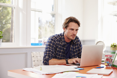 Man working from home on his laptop at desk