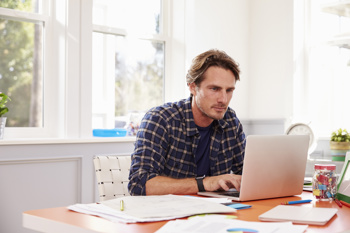 Man working from home on his laptop at desk