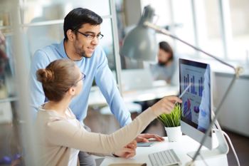 Man and women looking at procurement software