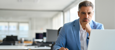 MAT leader thinking looking at laptop