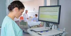 Ward nurse inputting information into an electronic health record