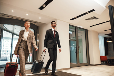 Two Business Travelers Entering A Hotel