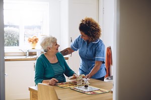 Carer with elderly woman delivering reflective practice