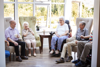 A group of elderly people sat in a circle. 
