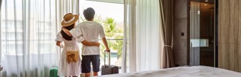 Couple in a hotel room looking at the view