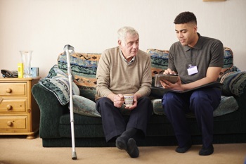 An elderly man and a social care worker.