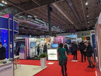 lady standing in busy conference room at Rewired 2024