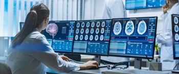 An NHS doctor using healthcare software for a clinical assessment.