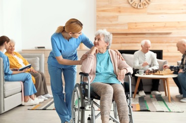 care working chatting with a resident in a wheelchair