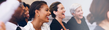 Image of the team laughing at a joke in a meeting at the office