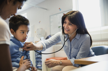 people conversing around a computer