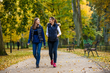 Two women walking, as part of a social prescribing support group.