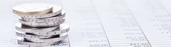 stack of coins on top of a payment register