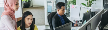 Image of employees having a quick discussion in the office