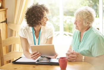 Carer and elderly lady discussing care