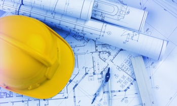  a hardhat sitting on top of papers
