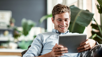 Smiling man on a tablet.