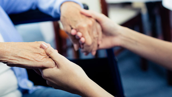 carer holding a resident's hands