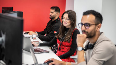 IT team members working at their desks.