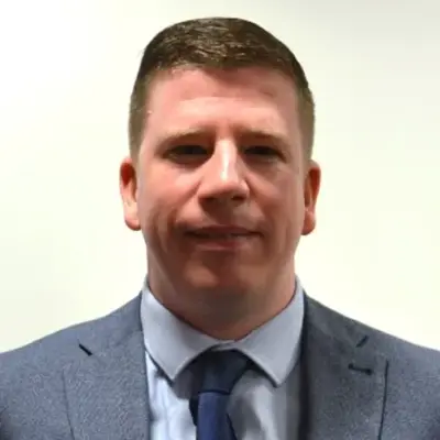 Client testimonial image showing a person in a suit and tie representing an Access Legal software user