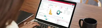 lady looking at brokerage graphs on laptop