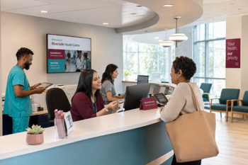 A mock-up of an NHS clinic reception desk.
