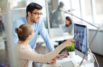 Man and women looking at cash flow forecasting software