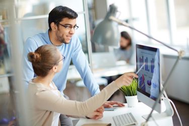 Man and women looking at cash flow forecasting software