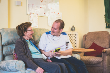 A male nurse consulting an elderly woman
