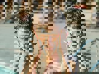 A child applying sunscreen on holiday.