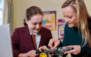 female teacher helping a student with a science project