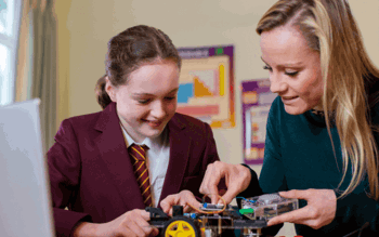 female teacher helping a student with a science project
