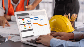 Image of a man in black shirt working on stock take using a tablet