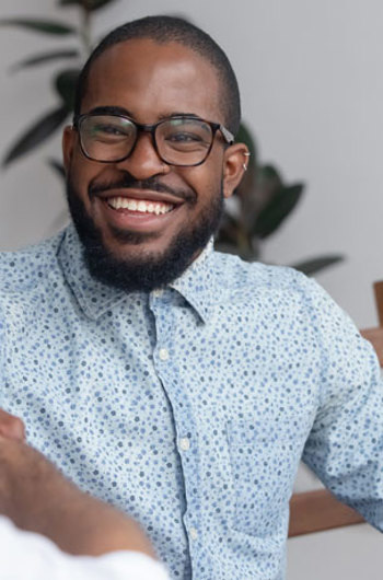 A man laughing and talking to others