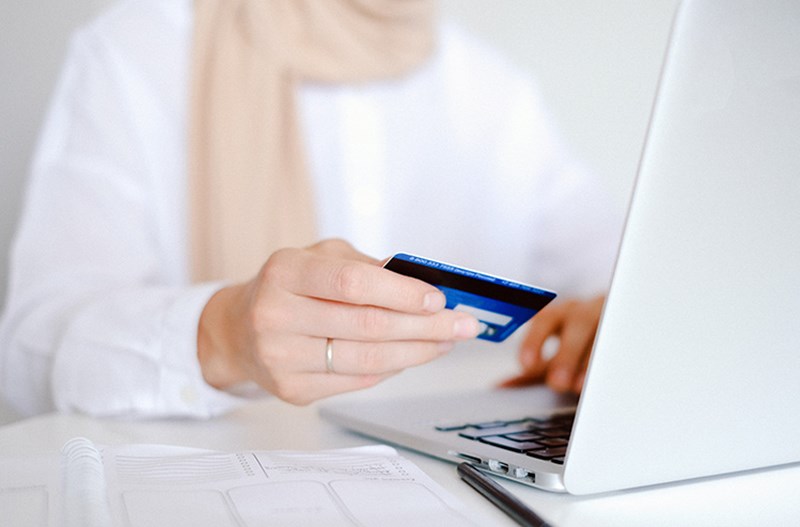 Woman purchasing something online with credit card