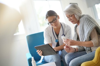 doctor with an elderly woman on her laptop